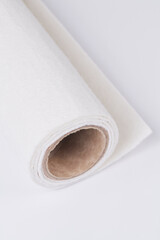 Soft felt textile material of beige color, colorful texture fabric roll closeup