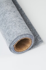 Soft felt textile material gray color, colorful texture fabric roll closeup
