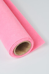 Soft felt textile material of pink color, colorful texture fabric roll close-up