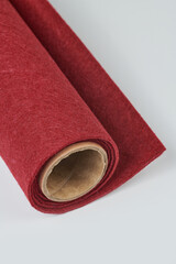 Soft felt textile material red pink colors, colorful texture fabric roll closeup