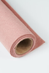 Soft felt textile material light brown colors, colorful texture fabric roll closeup