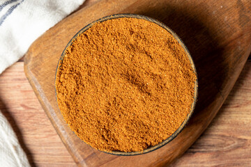Meatball spice in bowl on rustic table. Meatball seasoning is a spice mix consisting of cumin, coriander, ground red pepper, thyme, black pepper, onion, garlic and dried parsley. Dry spice concept