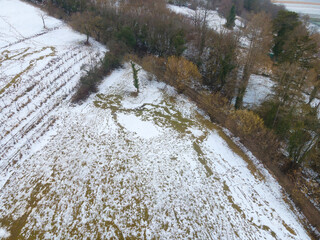 drone flight over landscape with very little snow and you can see the green meadow