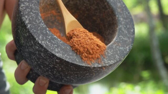Spoon pours out ground pepper