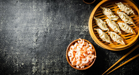 Dumplings gyoza with shrimp in a bamboo steamer. 