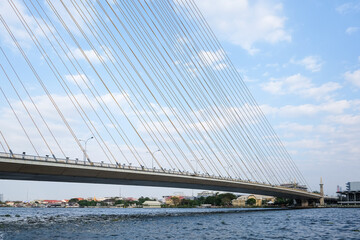 Fototapeta premium Thailand, Bangkok, view of the Rama VIII Bridge and the Chao Praya river under blue sky.