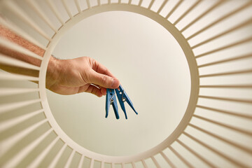 The clothespin is thrown into the trash for disposal and recycling. View from below. The concept of...