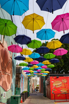 General view of colorful umbrellas above Orange Street Alley on January 12, 2022 in Downtown Redlands, California