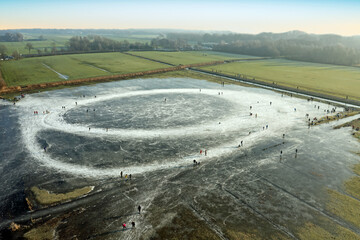 Aerial from ice skating on a lake in Friesland the Netherlands in winter © Nataraj
