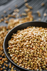 organic raw green buckwheat on a black background