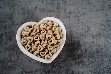 Heart shaped cereal valentines day background, selective focus