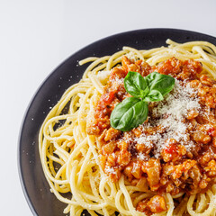 delicious Bolognese pasta on a black plate