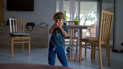 One happy little boy dancing indoor at home. 2 year old child dancer. Family lifestyle moment