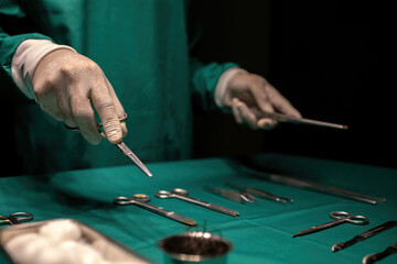 doctor preparing medical equipment performing surgery in operating room. nurse or professional...