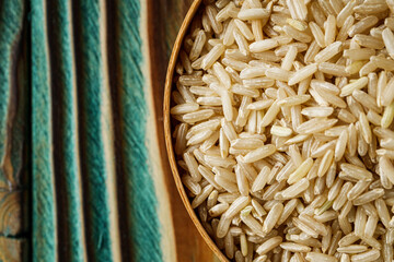 raw unpolished rice on a wooden rustic background