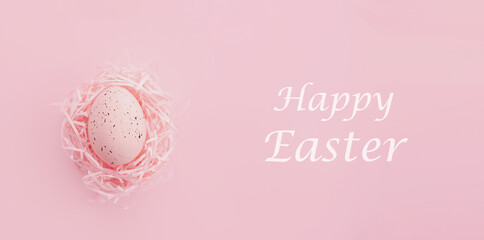 easter egg in nest on pink background with Flat lay. Spring composition. Happy easter greeting card. Copy space