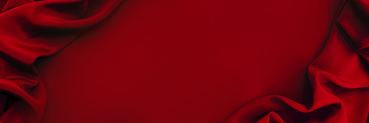 Dark red silk satin background. Bright folds on a shiny fabric. Valentine's Day. Luxury background...