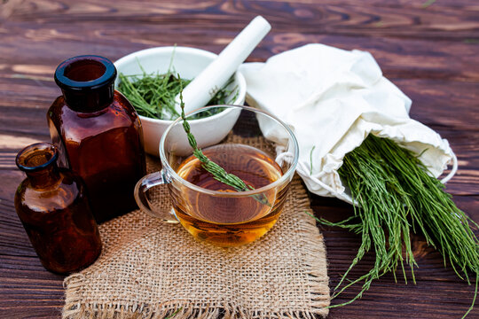 cup of tea from horsetail, made from fresh potion, from pharmacy mortar. 