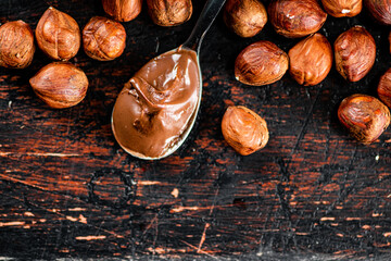 Hazelnut butter in a spoon on the table. 