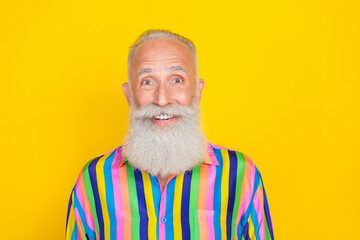Photo of cheerful sweet guy dressed striped colorful shirt smiling isolated yellow color background