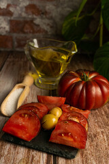 Agriculture and healthy eating, Moorish tomatoes from the garden with jar of oil and salt