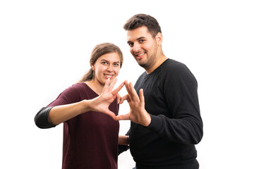 Boyfriend and girlfriend making heart gesture with fingers