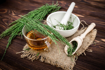 cup of tea from horsetail, made from fresh potion, from pharmacy mortar. 