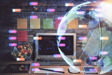 Double exposure of desktop with computer and world map hologram. International data network concept.