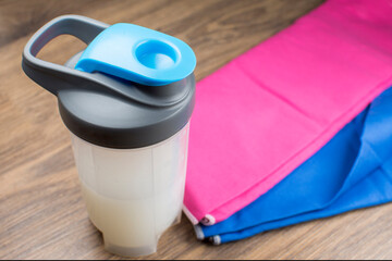 Shaker and microfiber towel for fitness and sport. Healthy nutrition.