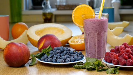 Raspberry Blueberry Melon Smoothie into a glass on the background of fresh fruits
