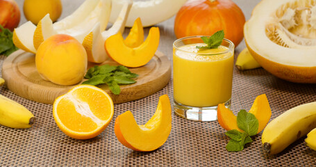 Melon banana Smoothie into a glass on the background of fresh fruits
