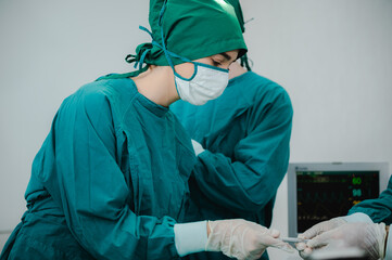 concentrated professional surgeons team during operation process in surgery by stand up through many hour surgeries, tumor cancer. surgical biopsy specimens. healthcare and medical concept.
