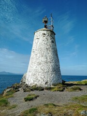Fototapeta na wymiar Goleudy Tŵr Bach Lighthouse on the Ynys Llanddwyn peninsula on the Welsh island of Anglesey