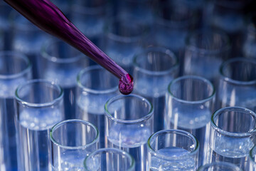 Pipette dropping fluid into test tube