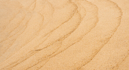 Sand texture backgrond.Top view Sandy beach,Natural sand stone texture with wave,Seaside view of Brown Beach sand dune in sunny day Spring,Wide Horizon for Summer banner backdrop background © Anchalee