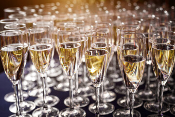The row of champagne glasses at the party.