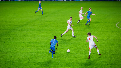 Stadium Soccer Football Match Championship: Blue Team Players Attacks, Plays in Pass. Action Game...