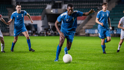 Soccer Football Match Championship: Blue Team Players with Forward Leading, Masterfully Dribbling. Action on Live Sport Channel Broadcast Television Game Concept.