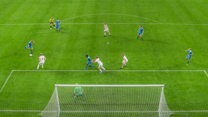 Stadium Soccer Football Match Championship: Blue Team Player Receives Successful Pass and Scores Perfect Goal. International Sport Broadcast. High Angle Shot from Behind the Goals