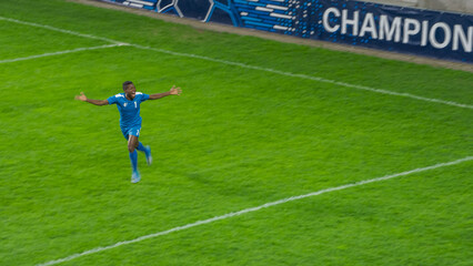 Soccer Football Championship Match: Blue Team: Attacker Running Happy after Scoring Winning Goal in the Tournament, Player Celebrate Victory. Sport Channel, Television Broadcast Concept.