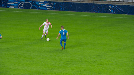 Stadium Soccer Football Match Championship: White Team Attacks and Plays in Pass. Action Game on a International Tournament. Live Sport Broadcast Channel Television Concept.