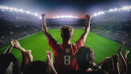 Establishing Shot of Fans Cheer for Their Favorite Team on a Stadium During Soccer Championship Final Match. Teams Play, Crowds of Fans Celebrate Victory and Goal. Live Football Cup Tournament Concept