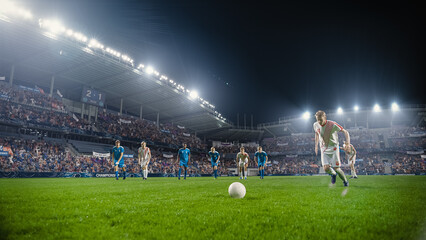 Football Championship: White Team Forward Hits the Ball and Scores Perfect Goal. Goalkeeper Jumps and Fails to Catch, Protect Goals. Crowd of Fans Cheers in Support. Beautiful Cinematic Edit. © Gorodenkoff