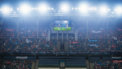 Football Soccer Championship Stadium Match, Scoreboard Screen Showing Repeat of the Goal. Crowd of Fans Cheering, Screaming, Having Fun. Sport Channel Television Advertising Concept.