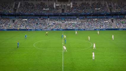 Fotobehang Soccer Football Championship Stadium with Crowd of Fans: Blue Team Starts The Game With Kick Off, Beginning of International Tournament Finals. Sport Channel Broadcast Television Concept. High Angle. © Gorodenkoff