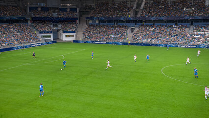 Soccer Football Championship Stadium with Crowd of Fans: Blue Team Forward Attacks, Dribbles,...