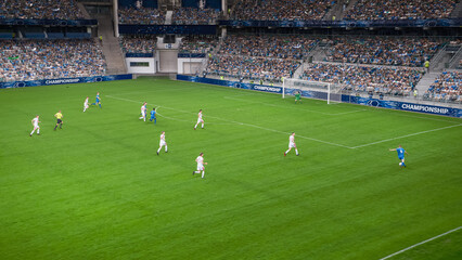 Soccer Football Championship Stadium with Crowd of Fans: Blue Team Forward Attacks, Dribbles,...