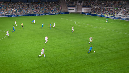 Soccer Football Championship Stadium with Crowd of Fans: Blue Team Forward Attacks, Dribbles, White Team Defending The Goals, Ready To Counterattack. Sports Channel TV Broadcast. High Angle.