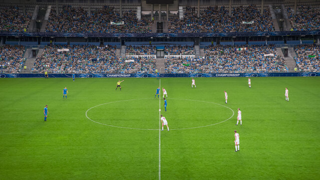 Soccer Football Championship Stadium with Crowd of Fans: Blue Team Starts The Game With Kick Off, Beginning of International Tournament Finals. Sport Channel Broadcast Television Concept. High Angle.
