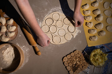 Sculpt dumplings. Make dumplings in the kitchen. Dough for dumplings. Ukrainian traditional dish....